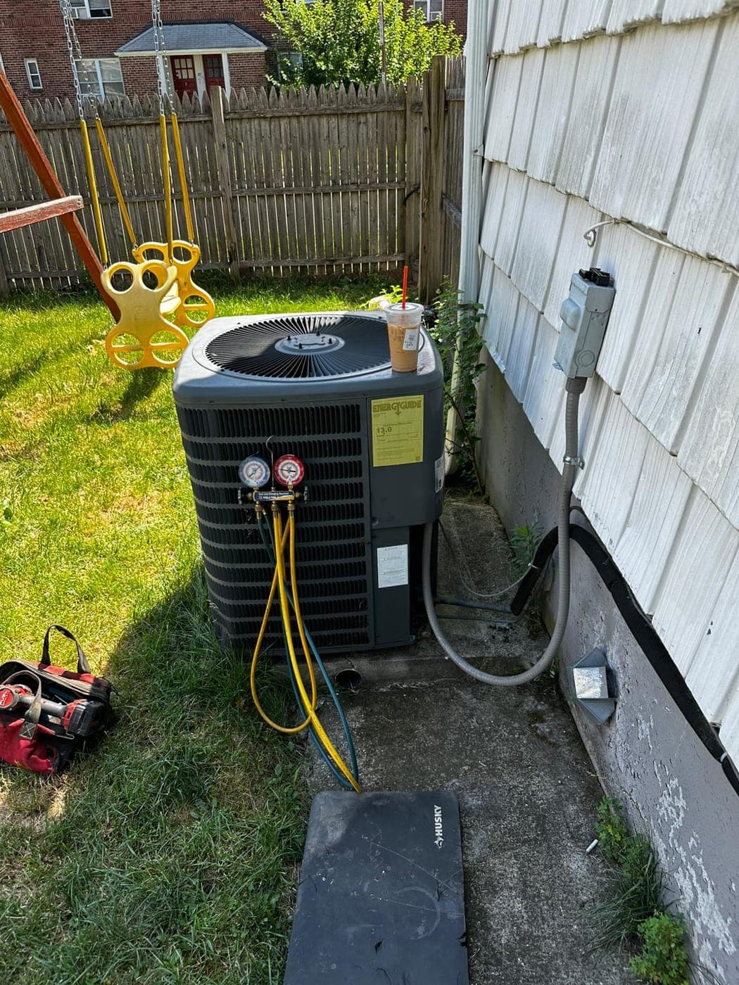 Outdoor heat pump unit being serviced at a North Jersey home