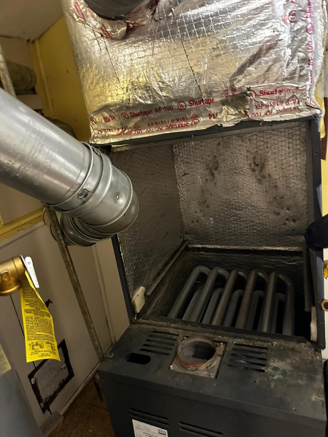 Gas furnace burner compartment and control board exposed for service
