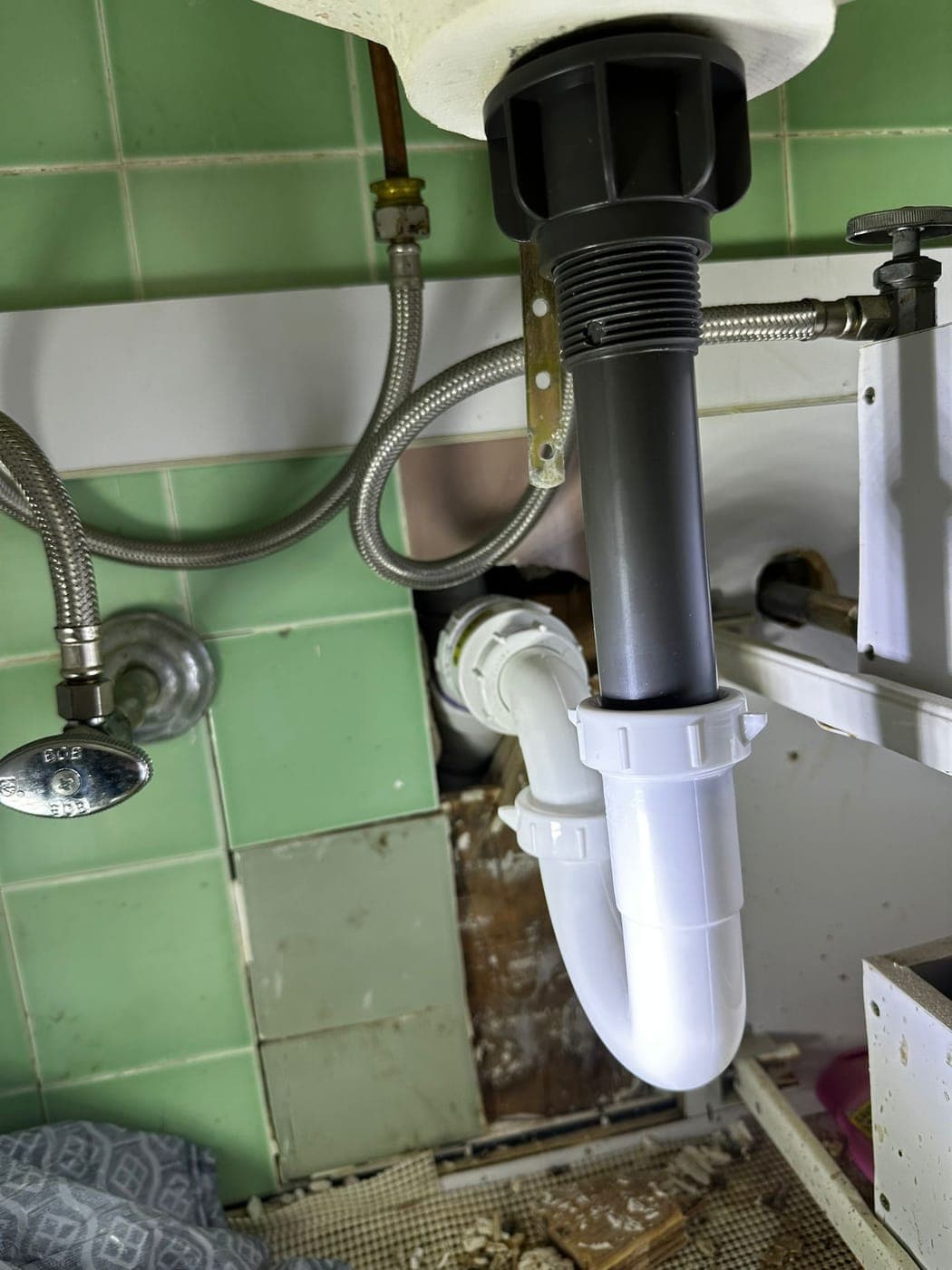 Kitchen sink drain, trap and disposal connections under a North Jersey kitchen sink