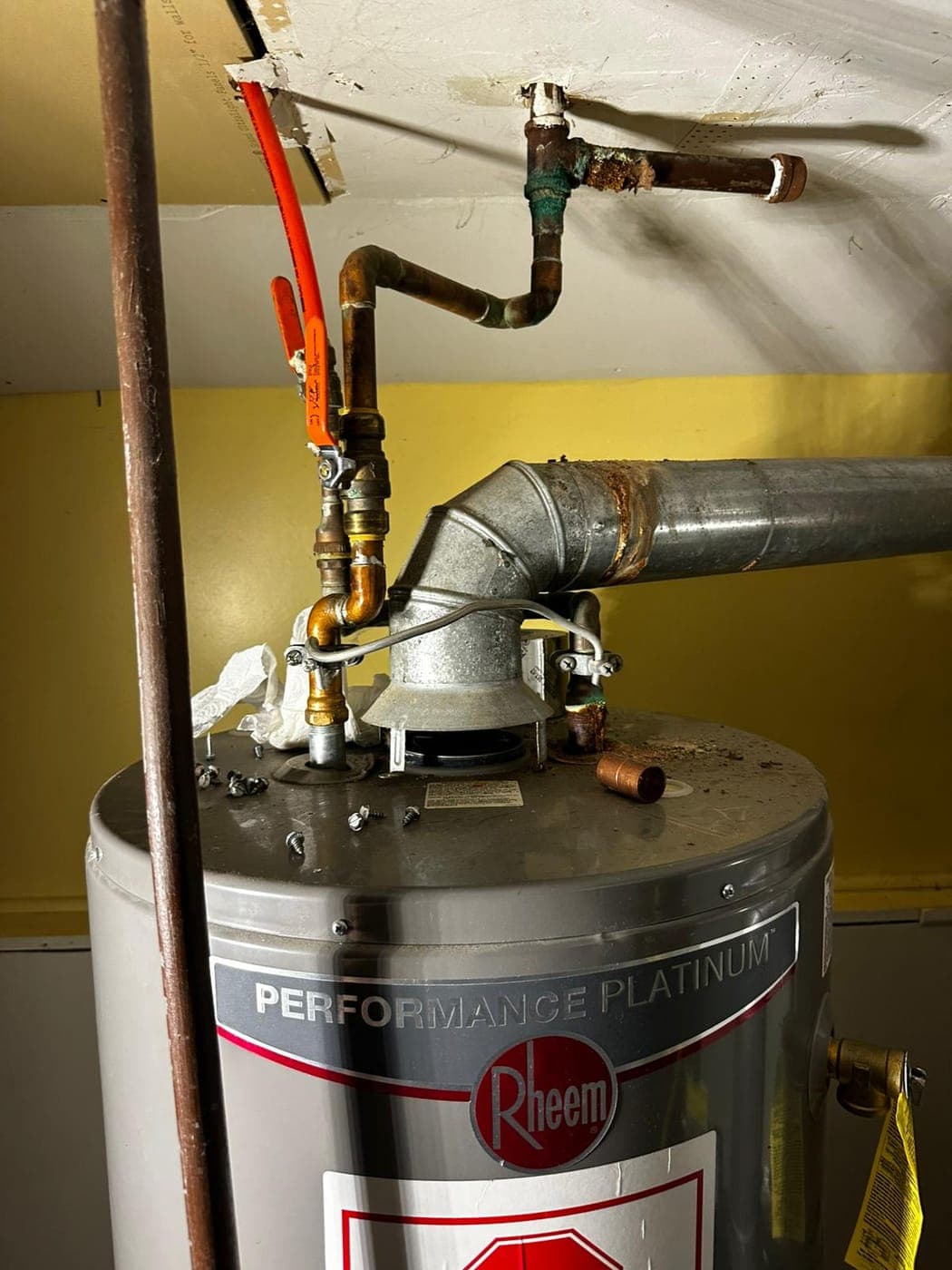 Gas boiler flue and copper piping in a North Jersey basement